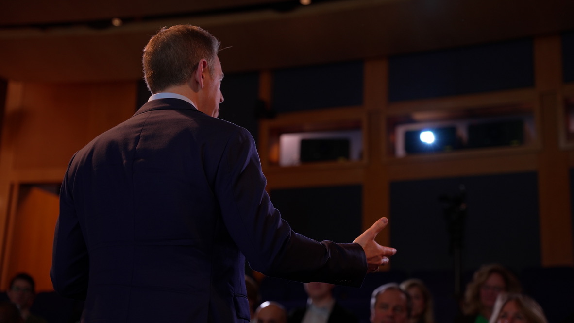 Mark Albert addressing an audience during a keynote